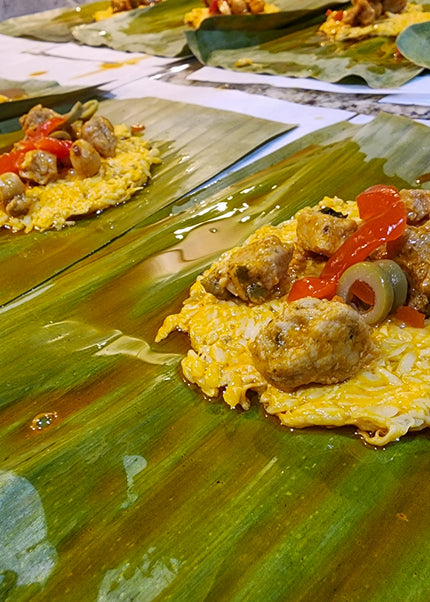 “Traditional Puerto Rican pasteles wrapped in banana leaves handmade weekly by Chef Shaby y Su Mai”