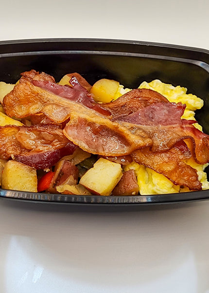 Scrambled eggs with bacon in a meal prep breakfast container