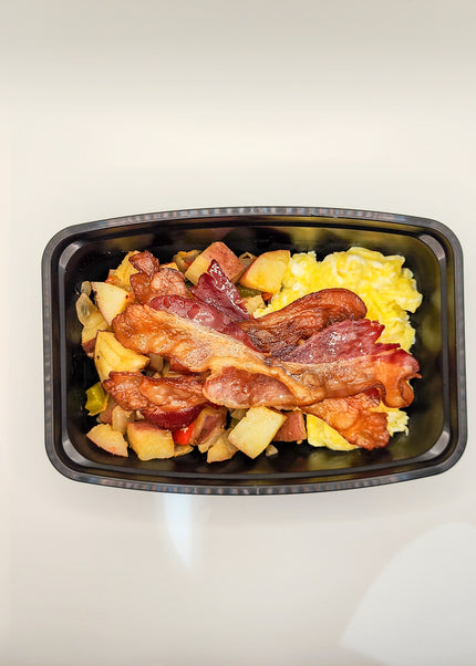 Scrambled eggs with bacon in a meal prep breakfast container