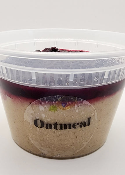Oatmeal topped with mixed berry compote in a clear container