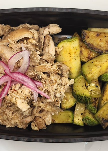 Pulled carnitas pork with seasoning in a Chef Shaby meal prep container