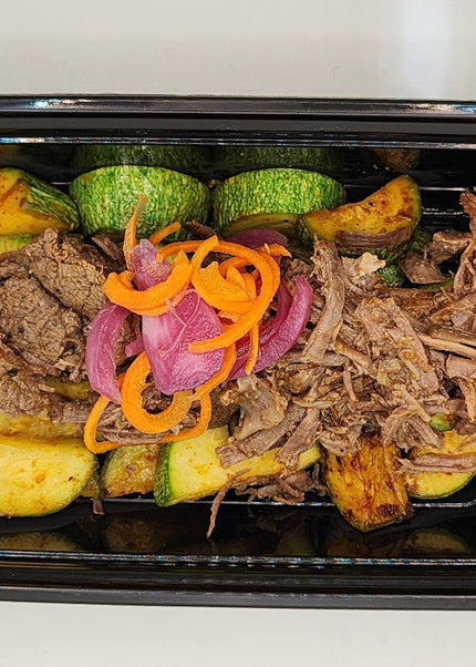 Shredded beef barbacoa with rich seasoning in a Chef Shaby meal prep container