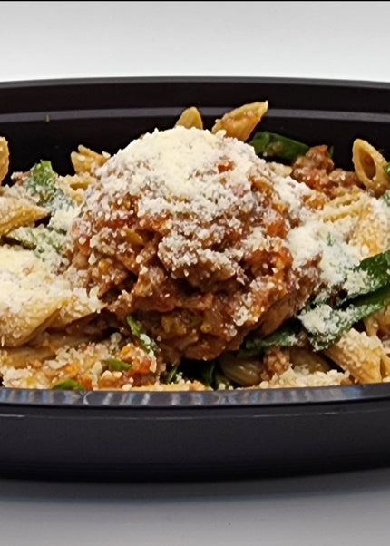 Beef bolognese sauce over pasta in a Chef Shaby meal prep container