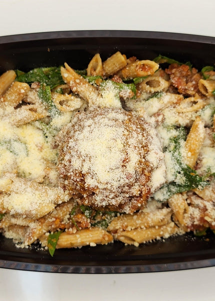 Beef bolognese sauce over pasta in a Chef Shaby meal prep container