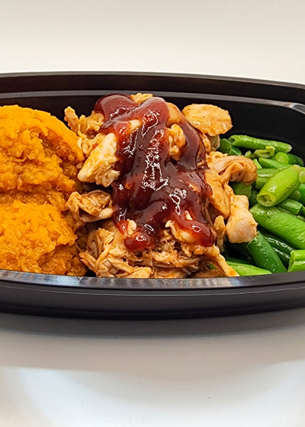 BBQ chicken breast with smoky sweet sauce in a meal prep container