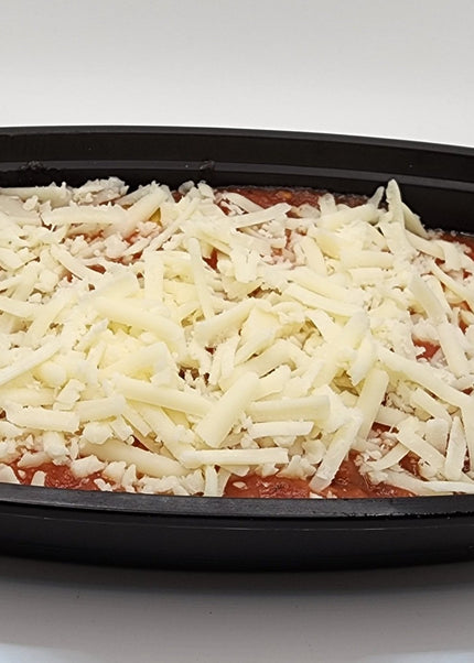 Slice of beef lasagna with cheese layers in a Chef Shaby meal prep container