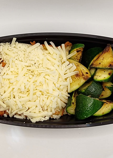 Slice of beef lasagna with cheese layers in a Chef Shaby meal prep container