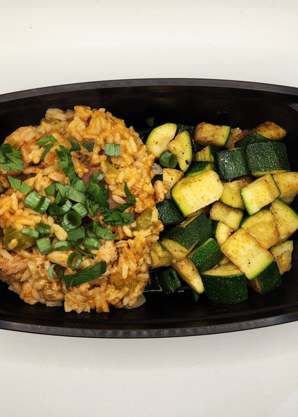 Chicken and sausage jambalaya with seasoned rice in a Chef Shaby meal prep container