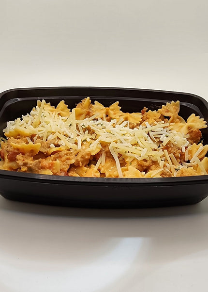 Italian sausage pasta with creamy pink sauce in a meal prep bowl