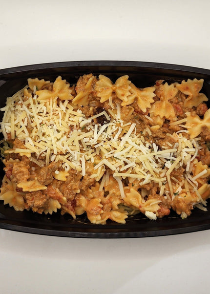Italian sausage pasta with creamy pink sauce in a meal prep bowl
