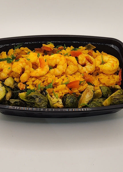Shrimp and sausage paella with seasoned rice and peppers in a meal prep tray