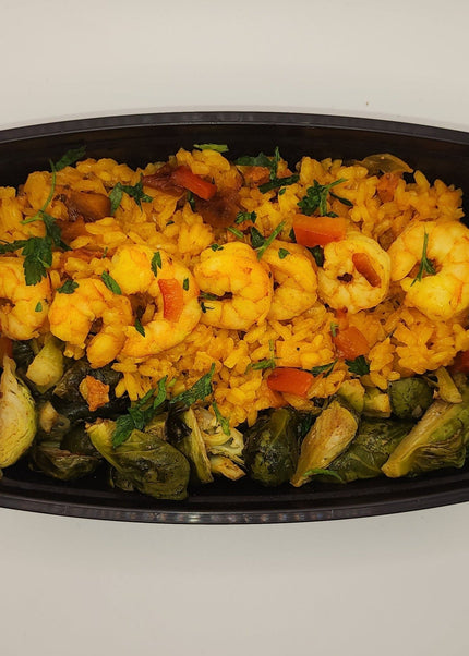 Shrimp and sausage paella with seasoned rice and peppers in a meal prep tray