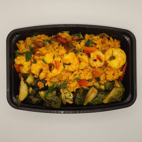 Shrimp and sausage paella with seasoned rice and peppers in a meal prep tray