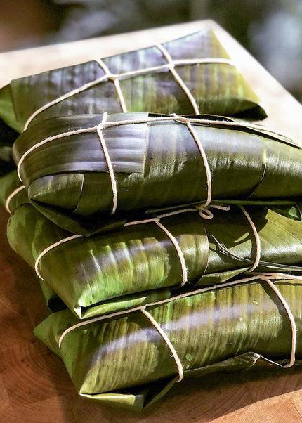 “Traditional Puerto Rican pasteles wrapped in banana leaves handmade weekly by Chef Shaby y Su Mai”